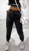 Faux Leather Joggers In Black - Dressmedolly